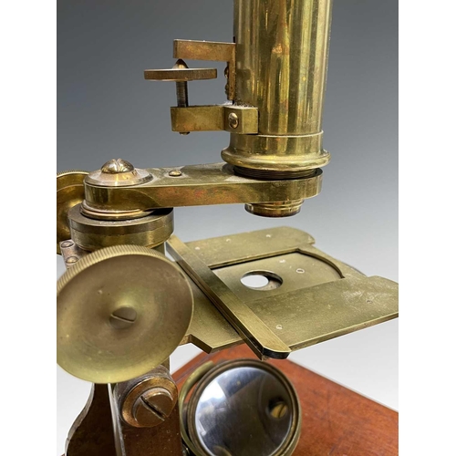 164 - A late Victorian brass microscope, with lenses, contained in a mahogany case with fitted drawer, ove... 