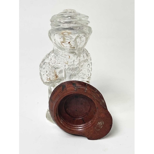 167 - A 1920s perfume bottle, moulded as a small boy, the cover modelled as a bakelite cap, height 8cm, to... 