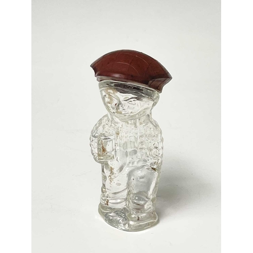 167 - A 1920s perfume bottle, moulded as a small boy, the cover modelled as a bakelite cap, height 8cm, to... 