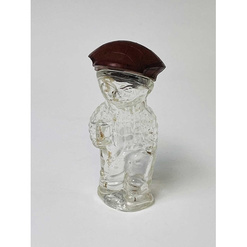 167 - A 1920s perfume bottle, moulded as a small boy, the cover modelled as a bakelite cap, height 8cm, to... 