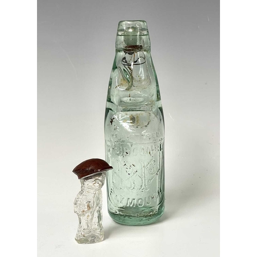 167 - A 1920s perfume bottle, moulded as a small boy, the cover modelled as a bakelite cap, height 8cm, to... 