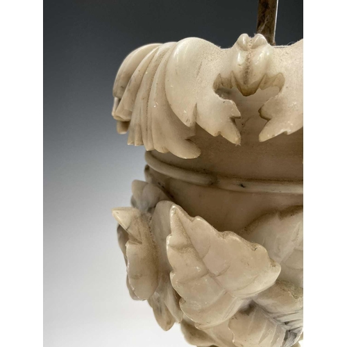 172 - A pair of carved alabaster table lamps, probably circa 1920, with leaf and rose carved relief decora... 