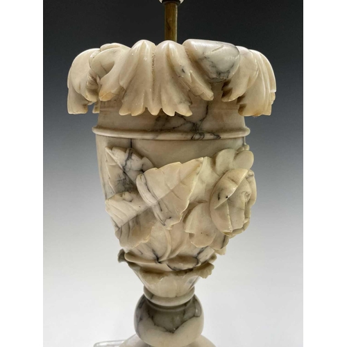 172 - A pair of carved alabaster table lamps, probably circa 1920, with leaf and rose carved relief decora... 