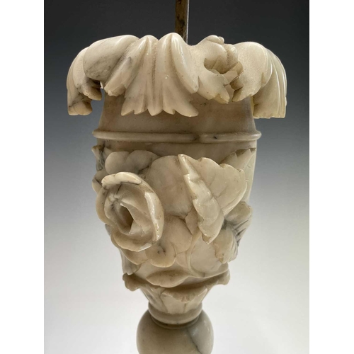 172 - A pair of carved alabaster table lamps, probably circa 1920, with leaf and rose carved relief decora... 