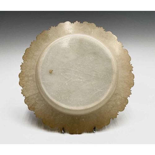 177 - An alabaster circular dish, possibly Indian, 19th century, with shaped and leaf carved border, with ... 