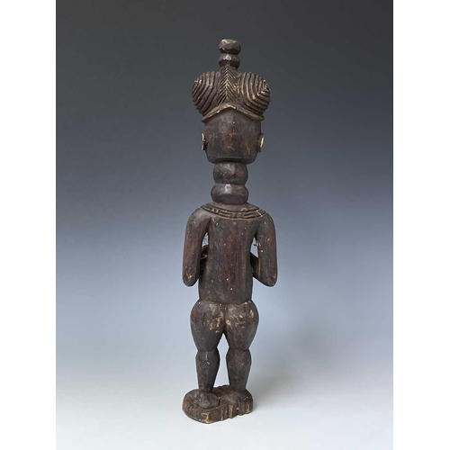 181 - A carved wood South Sea island figure. Height 59.5cm.