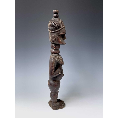 181 - A carved wood South Sea island figure. Height 59.5cm.