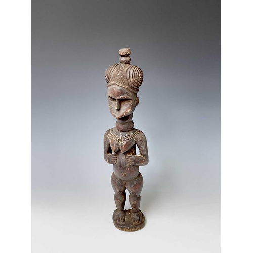 181 - A carved wood South Sea island figure. Height 59.5cm.