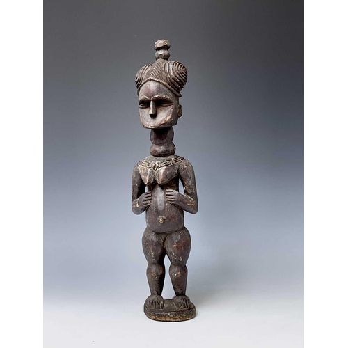 181 - A carved wood South Sea island figure. Height 59.5cm.