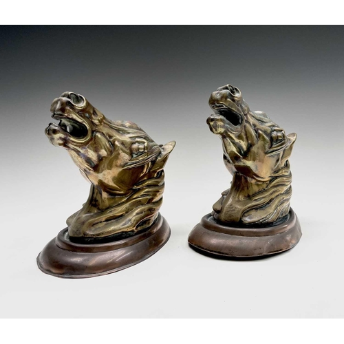 188 - A pair of brass horses' masks raised on copper wall mounts. Height 19cm, width 11.5cm, depth 18.5cm.