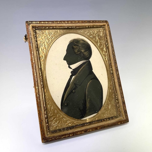 199 - A mid-19th century silhouette portrait of a gentleman, heightened in gilt and white, 6.5X5.5cm, toge... 