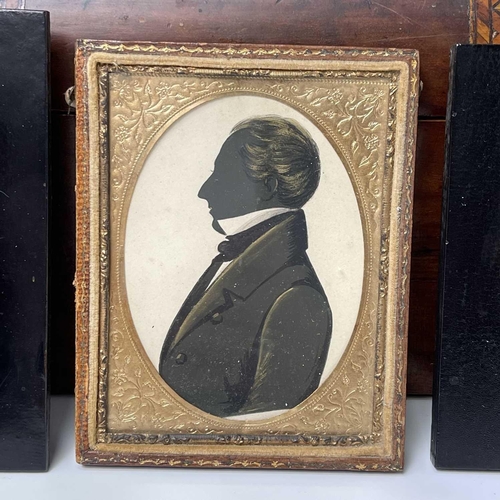 199 - A mid-19th century silhouette portrait of a gentleman, heightened in gilt and white, 6.5X5.5cm, toge... 