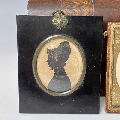 199 - A mid-19th century silhouette portrait of a gentleman, heightened in gilt and white, 6.5X5.5cm, toge... 