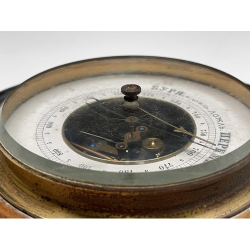 206 - An aneroid barometer, contained in a Cornish serpentine circular case, diameter 17cm, together with ... 