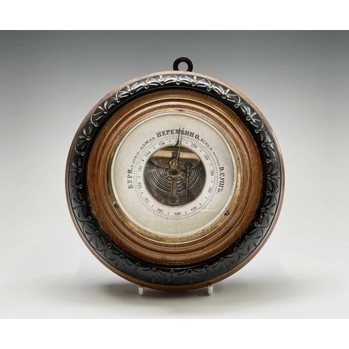 206 - An aneroid barometer, contained in a Cornish serpentine circular case, diameter 17cm, together with ... 