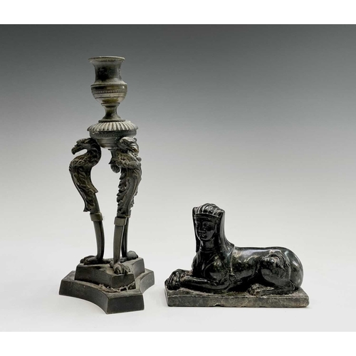 207 - A Regency bronze candlestick, the nozzle supported by three eagle headed monopodia, on a triform bas... 