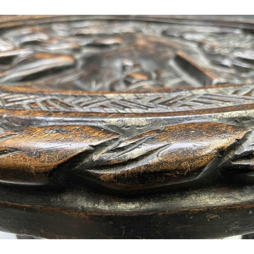 208 - An African circular hardwood occasional table, the top carved with an elephant, eagle, antelope, tor... 