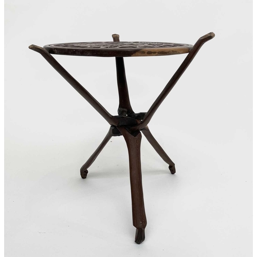 209 - An African carved hardwood table, raised on a folding tripod base, diameter 44cm.