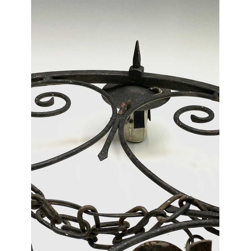 235 - A Gothic style wrought iron hanging electrolier, diameter 53cm, together with four similar twin bran... 