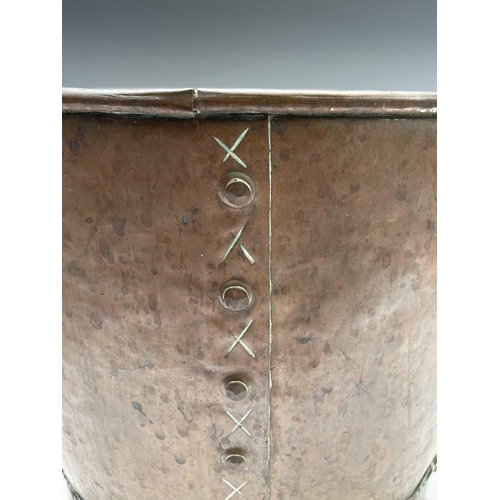 242 - A copper log bin, circa 1920, with twin handles and raised on brass paw feet, height 31cm, diameter ... 