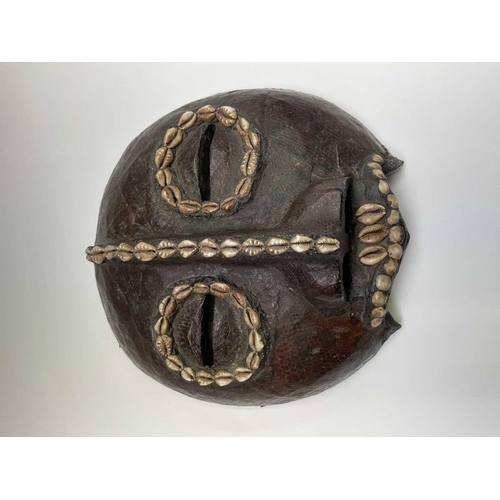 244 - A 19th century African tribal mask, with applied snakeskin and cowrie shell decoration, height 27.5c... 