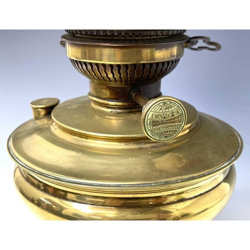 246 - A Victorian 'Invicta' brass oil lamp, raised on circular glazed black ceramic base, with white opaqu... 