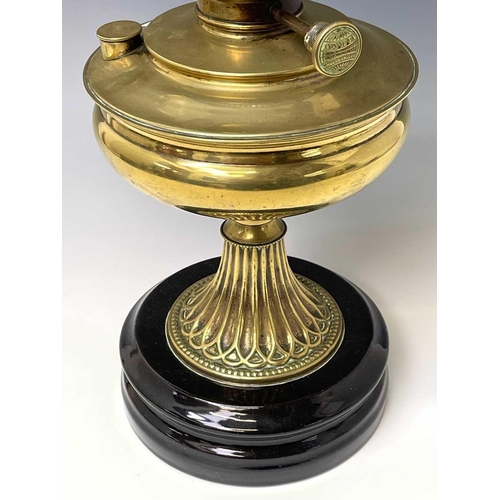 246 - A Victorian 'Invicta' brass oil lamp, raised on circular glazed black ceramic base, with white opaqu... 