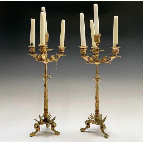 25 - A pair of gilt metal ornate candelabra, probably French, circa 1890, each with a central sconce and ... 