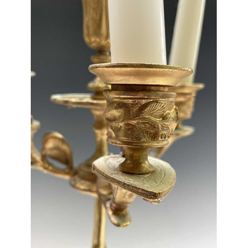 25 - A pair of gilt metal ornate candelabra, probably French, circa 1890, each with a central sconce and ... 