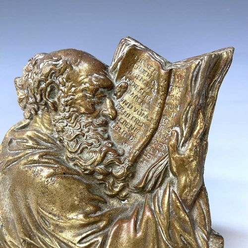 252 - A Victorian brass plaque, cast as a philosopher reading a book, height 18cm.