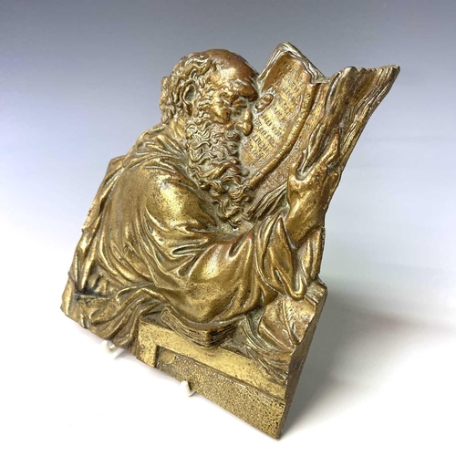 252 - A Victorian brass plaque, cast as a philosopher reading a book, height 18cm.