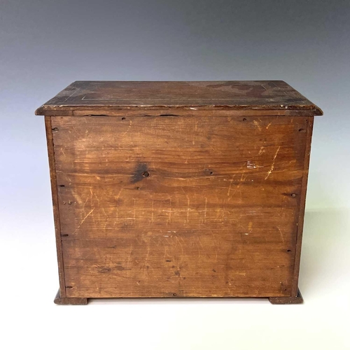 253 - A Victorian walnut apprentice chest of two short and two long drawers, with twist turned stiles, sta... 