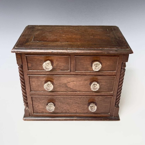 253 - A Victorian walnut apprentice chest of two short and two long drawers, with twist turned stiles, sta... 