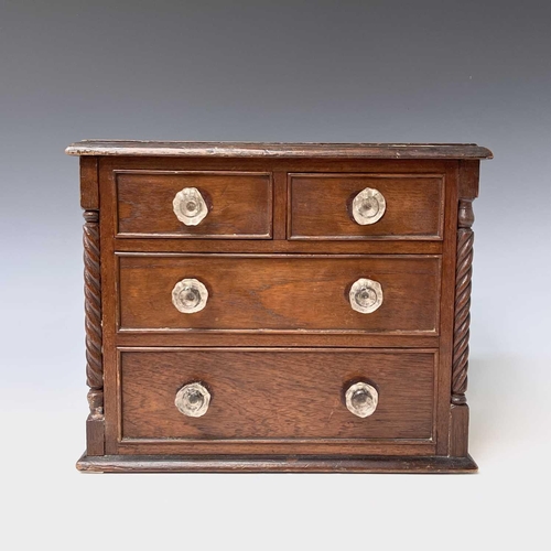 253 - A Victorian walnut apprentice chest of two short and two long drawers, with twist turned stiles, sta... 