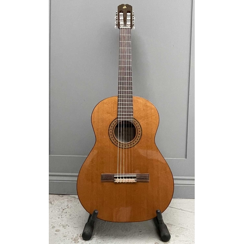 257 - An Admira Spanish-type classical guitar with stand and soft case.