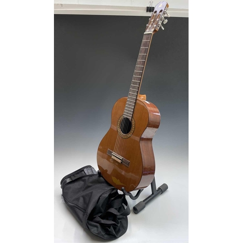 257 - An Admira Spanish-type classical guitar with stand and soft case.