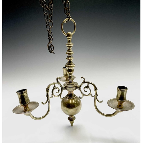 258 - A brass three branch chandelier, 20th century in the Dutch 18th century style, with numbered scroll ... 