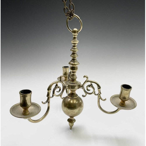 258 - A brass three branch chandelier, 20th century in the Dutch 18th century style, with numbered scroll ... 