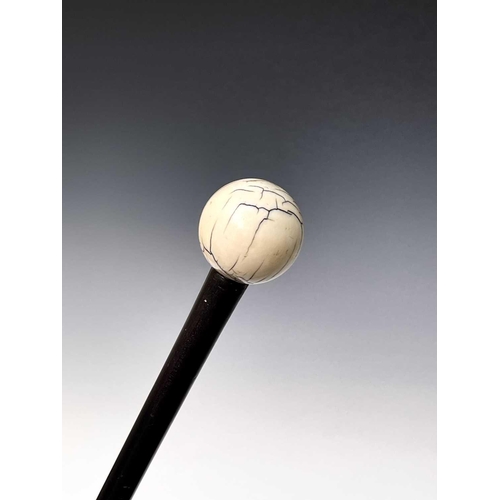 267 - An early 20th century ebonised wood walking cane with turned ivory knop. Height 84.5cm.