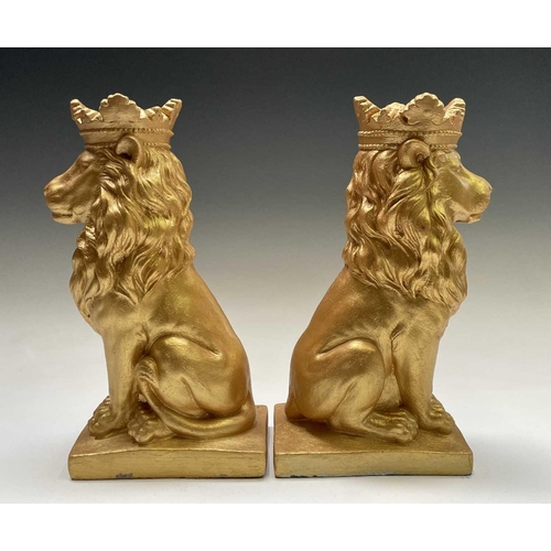 268 - A pair of gold painted seated lions wearing crowns. Height 35cm.