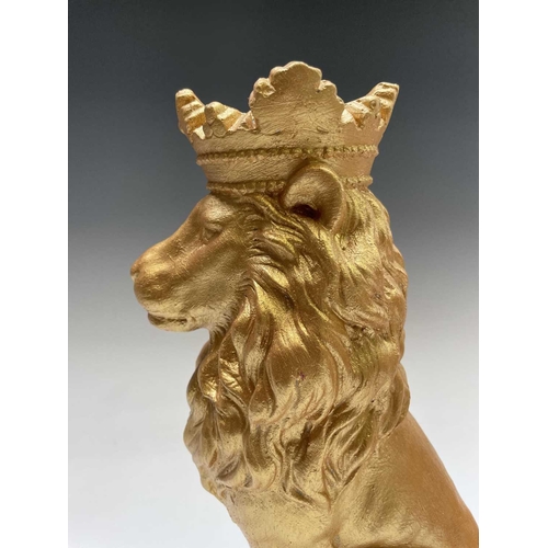 268 - A pair of gold painted seated lions wearing crowns. Height 35cm.