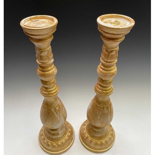 269 - A pair of large gold painted candle stands. Height 64cm.