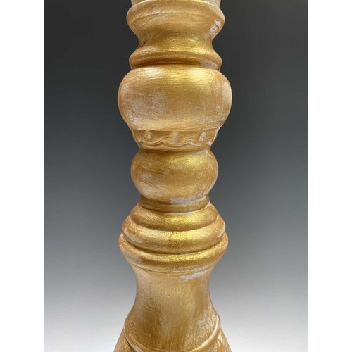 269 - A pair of large gold painted candle stands. Height 64cm.