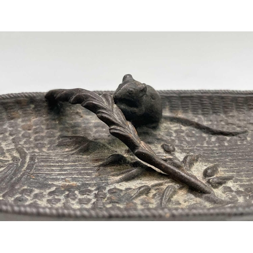 276 - A 20th century cast bronze sculpture of a mouse eating a sheaf of corn in a basket. Width 17.5cm.