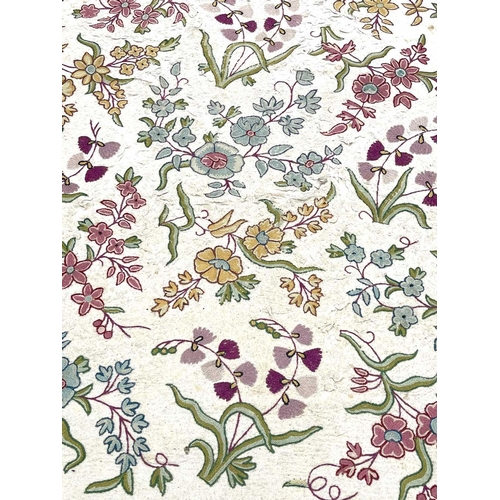 2800 - A cream ground rug/wall hanging with floral crewelwork decoration. 177 x 118.5cm.