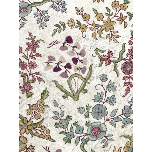 2800 - A cream ground rug/wall hanging with floral crewelwork decoration. 177 x 118.5cm.