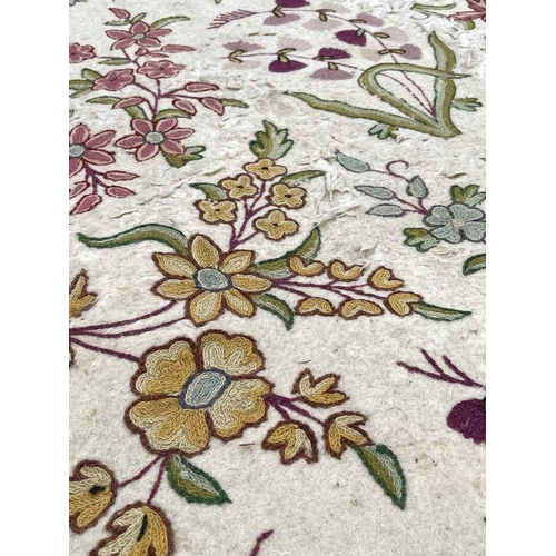 2800 - A cream ground rug/wall hanging with floral crewelwork decoration. 177 x 118.5cm.