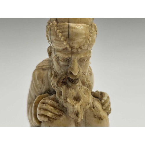 282 - A 19th century Dieppe ivory figure of a bearded man wearing a turban squatting, inscribed and dated ... 