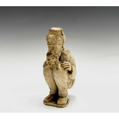 282 - A 19th century Dieppe ivory figure of a bearded man wearing a turban squatting, inscribed and dated ... 