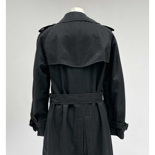 2823 - A ladies Burberry Prorsum black belted trench raincoat with Burberry check lining, label size long 1... 